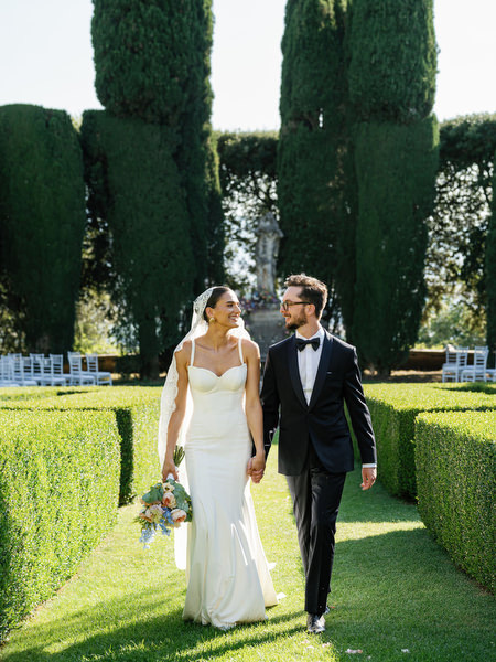 Overhead portrait of newlyweds walking through Renaissance hedge maze in Tuscany