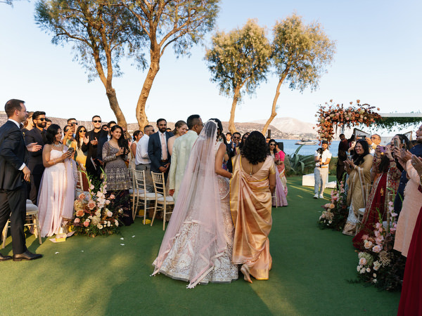 Bride walking down the aisle surrounded by guests at Island Resort the Residence on the Athens Riviera