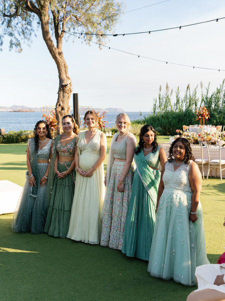 Bridesmaids posing on the ceremony lawn at Island Resort the Residence during an Athens Riviera Indian wedding
