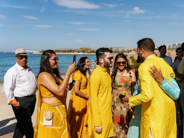 Friends greeting each other during Haldi ceremony celebration
