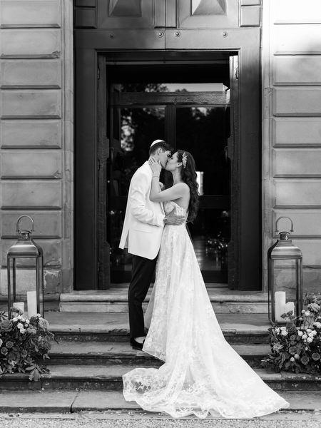 Bride and groom at historic entrance of Villa Corsini a Mezzomonte, Florence wedding venue in Tuscany.