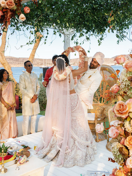 Playful wedding ritual moment under the floral mandap at Island Resort the Residence