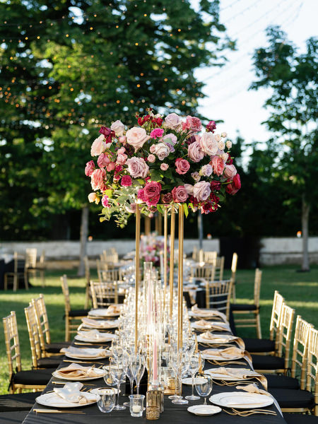 Luxury reception table with elevated pink floral centerpieces at Villa Corsini a Mezzomonte wedding in Florence.
