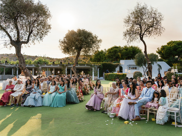 Guests seated on the ceremony lawn at Island Resort the Residence during a luxury Indian wedding in Athens