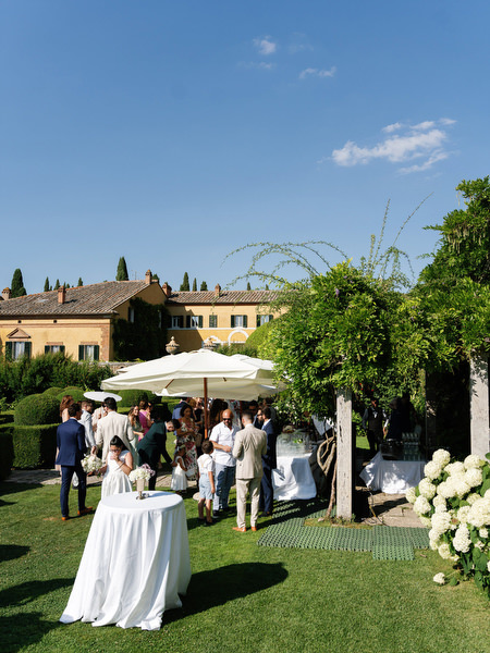 Elegant outdoor cocktail reception setup at La Foce estate in the Tuscan countryside