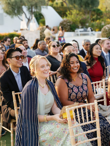 Guests smiling during the ceremony at Island Resort the Residence overlooking the Athens Riviera