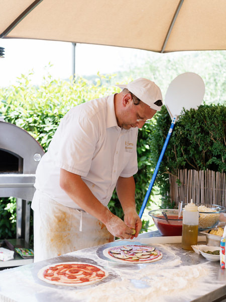 Chef preparing food at Borgo I Vicelli pool party celebration