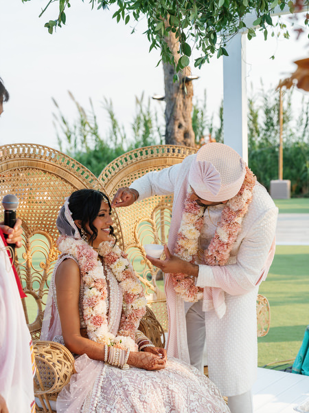 Groom placing garland during the Hindu ceremony at Island Resort the Residence on the Athens Riviera