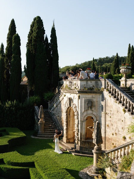 Guests gathering on historic terrace during cocktail hour at La Foce in Tuscany