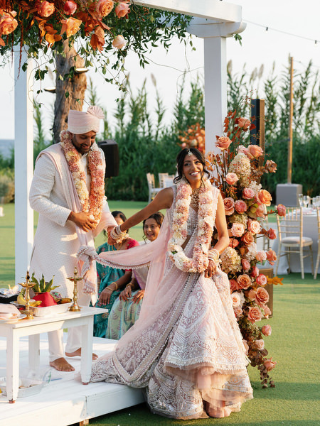 Bride stepping forward during the ceremony beneath floral mandap at Island Resort the Residence