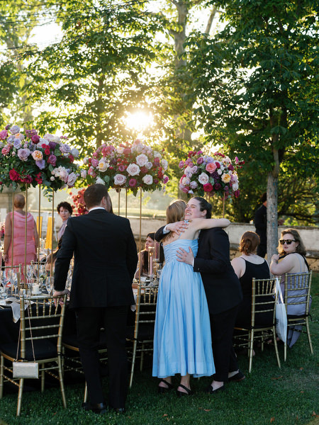 Guests embracing during golden hour reception at Villa Corsini Tuscany, Florence Jewish wedding.