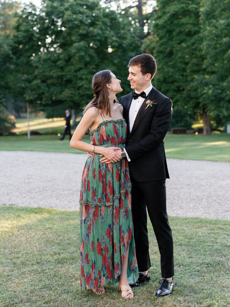 Guests embracing at Villa Corsini gardens during luxury wedding in Florence, Tuscany.