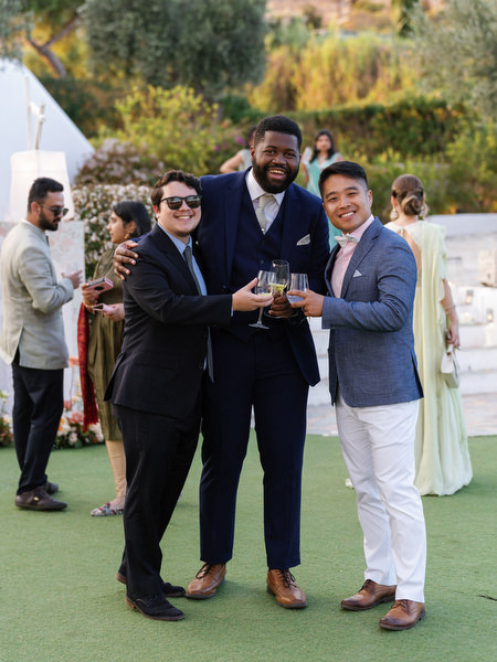 Guests raising glasses in celebration at Island Resort the Residence during an Indian wedding in Athens
