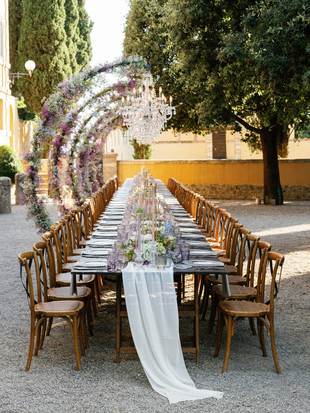Elegant long reception table styled for luxury Tuscany wedding at historic Italian estate