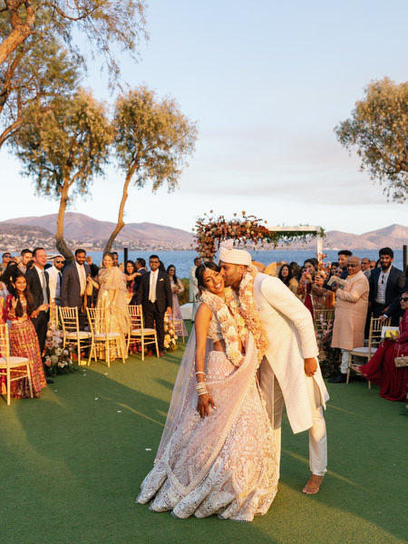 Bride and groom dancing on the ceremony lawn at Island Resort the Residence on the Athens Riviera