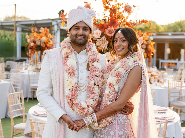 Bride and groom portrait with floral garlands at Island Resort the Residence during their Athens Riviera Indian wedding