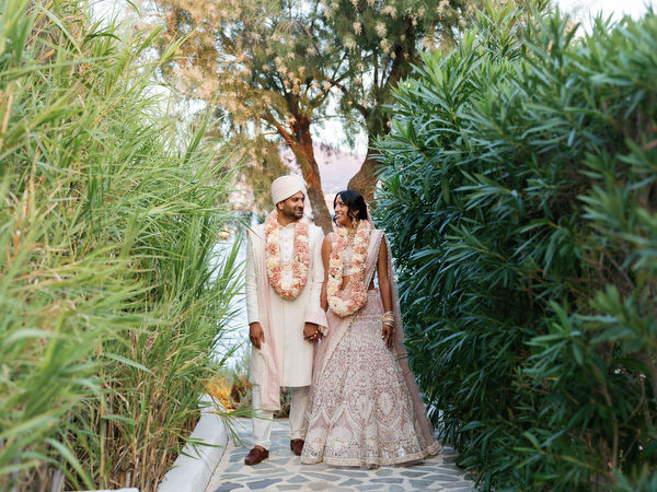 Couple walking through Mediterranean greenery at Island Resort the Residence on the Athens Riviera