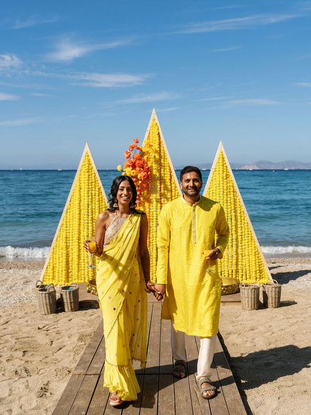 Couple walking together at Haldi ceremony on Athenian Riviera