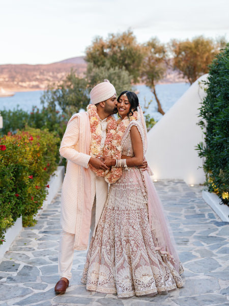Bride and groom walking along stone pathway at Island Resort the Residence in Athens