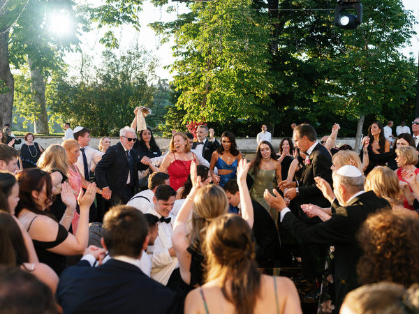 Wedding guests celebrating during Jewish hora at Villa Corsini a Mezzomonte in Florence, Italy.