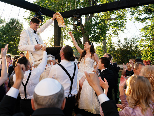 Groom dancing at sunset during Jewish wedding reception at Villa Corsini in Florence, Italy.