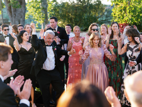 Guests celebrating beneath disco balls at Villa Corsini Tuscany, Florence Jewish wedding reception.