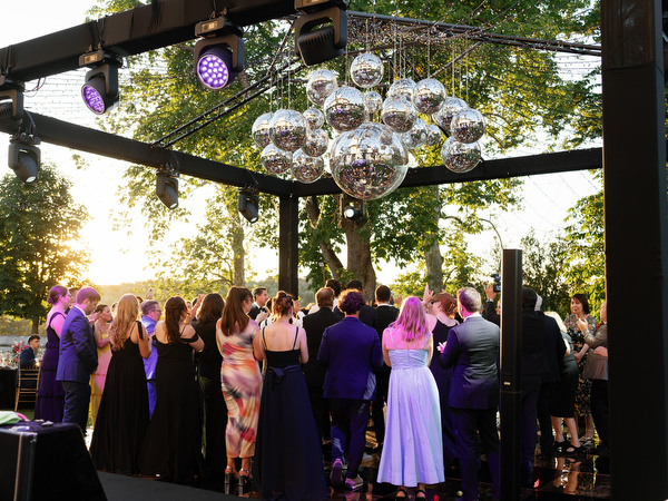 Guests celebrating beneath disco balls at Villa Corsini Tuscany, Florence Jewish wedding reception.