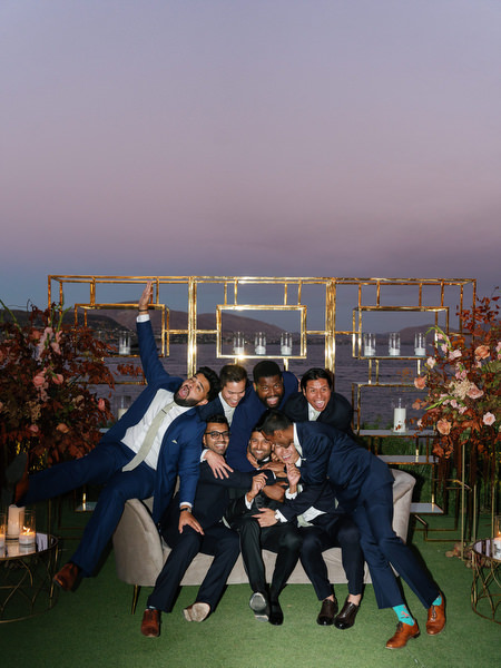 Group of friends posing at sunset reception lounge at Island Resort the Residence on the Athens Riviera