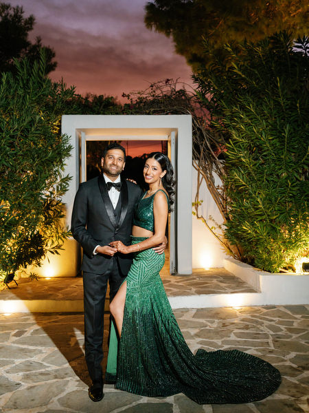 Couple portrait at night beside white Mediterranean architecture at Island Resort the Residence