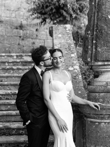 Timeless black and white portrait of couple embracing on Italian villa staircase