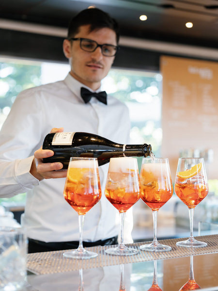 Bartender serving Aperol Spritz cocktails at Florence welcome party