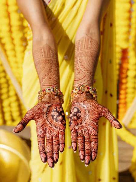 Mehndi hands detail during Haldi ceremony celebration