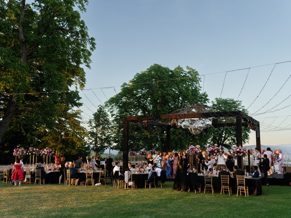 Wide view of Jewish wedding dance floor at Villa Corsini Tuscany during sunset reception.