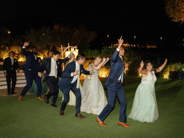 Guests dancing on the lawn at Island Resort the Residence Indian wedding in Athens