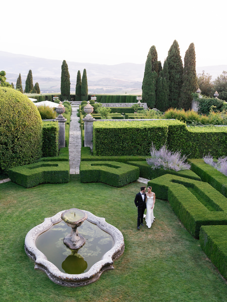 Ornate fountain surrounded by symmetrical hedges at La Foce estate in Tuscany