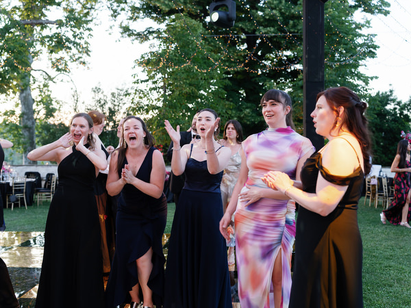 Bridesmaids reacting emotionally during Jewish wedding reception at Villa Corsini in Florence, Tuscany.