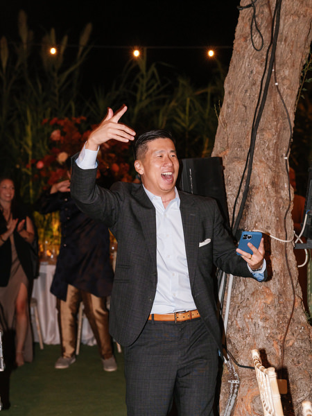 Guest cheering during nighttime reception at Island Resort the Residence on the Athens Riviera
