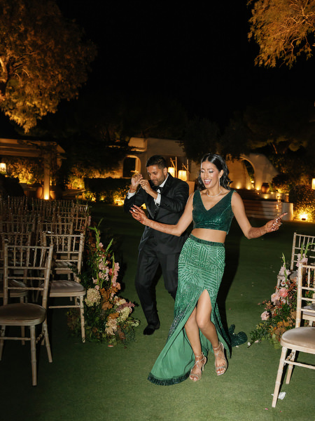 Couple dancing on the lawn at Island Resort the Residence during Indian wedding reception in Athens