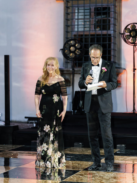 Parents giving speech on stage at Villa Corsini a Mezzomonte Jewish wedding reception.