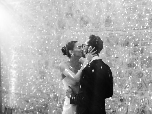 Bride and groom kissing during candlelit first dance at La Foce wedding in Tuscany