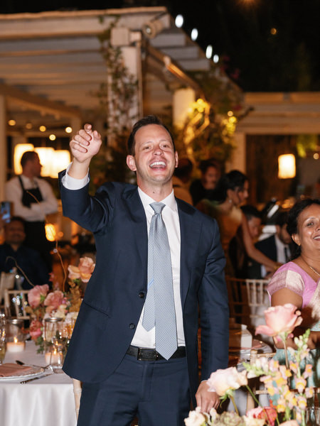 Guest raising hand during lively reception at Island Resort the Residence