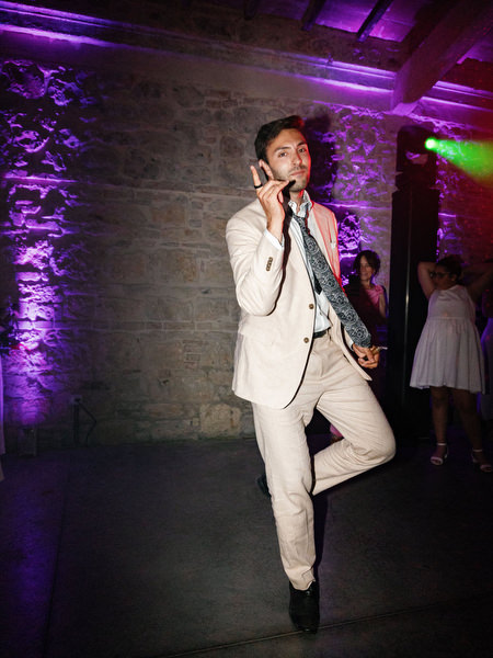 Guest dancing on reception floor under dramatic lighting at Italian wedding celebration