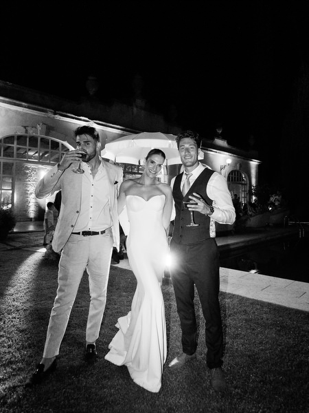Bride taking a celebratory shot during energetic Tuscany wedding after-party