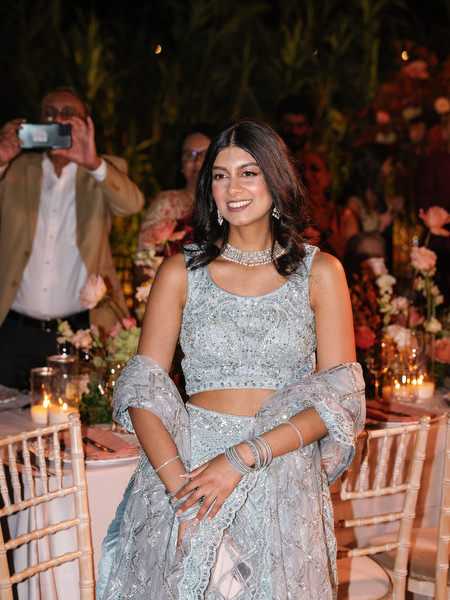Guest smiling at reception tables at Island Resort the Residence during Athens Riviera wedding