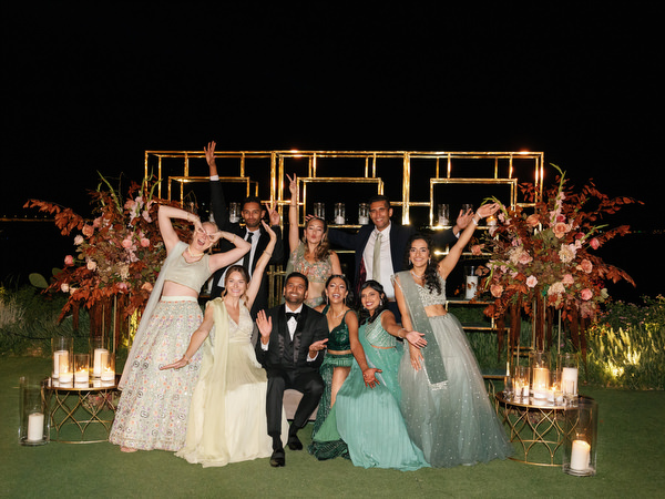 Friends posing in formalwear during reception at Island Resort the Residence