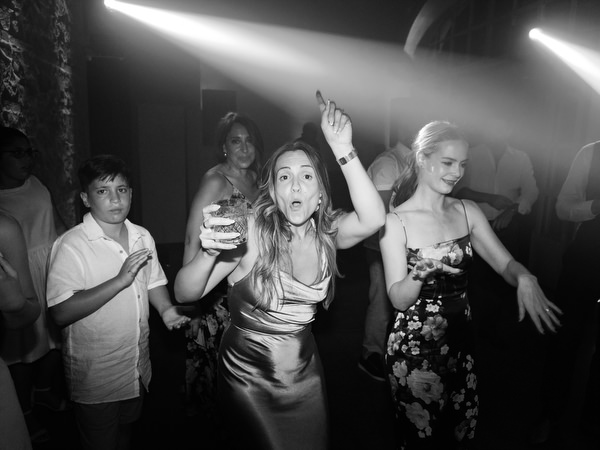 Guests dancing enthusiastically during high-energy luxury wedding reception