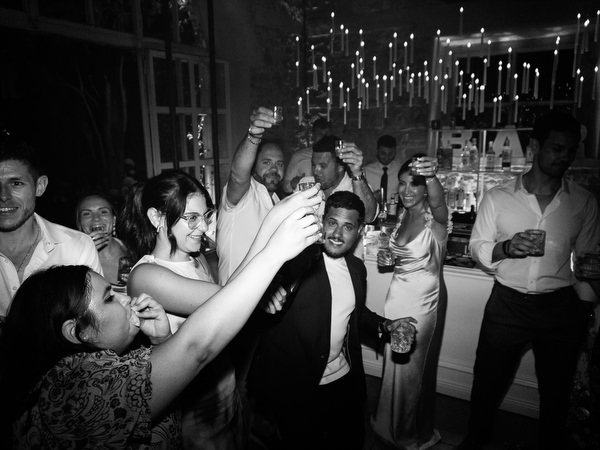 Guests dancing enthusiastically during high-energy luxury wedding reception