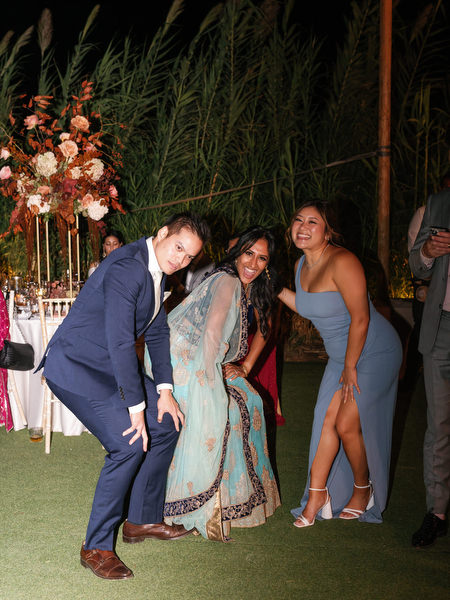 Guests playfully posing on reception lawn at Island Resort the Residence