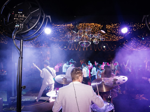 Live band performing as guests dance under disco balls at Villa Corsini a Mezzomonte wedding in Florence.