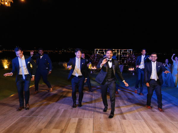 Groomsmen dancing in formation on dance floor at Island Resort the Residence